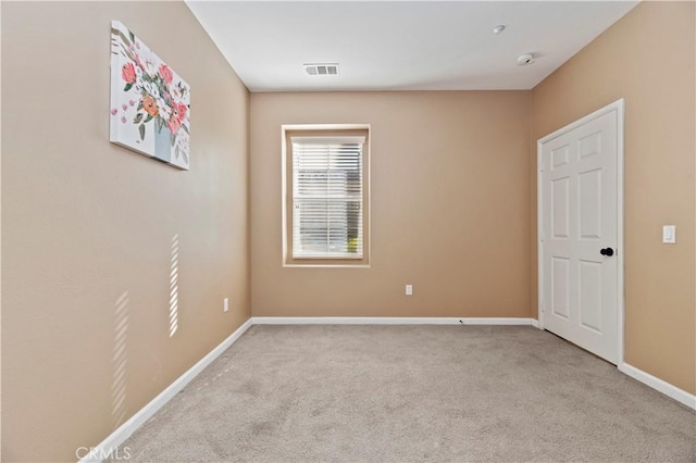 empty room featuring light carpet