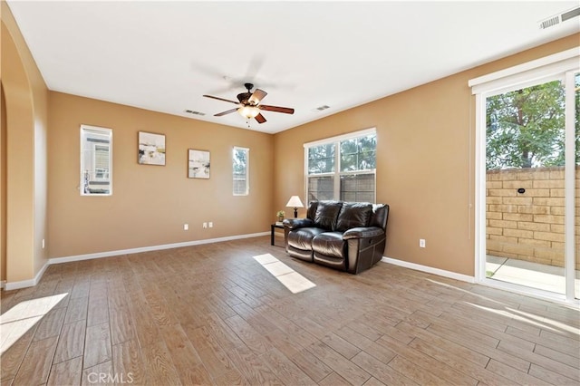 living area with ceiling fan and light wood-type flooring