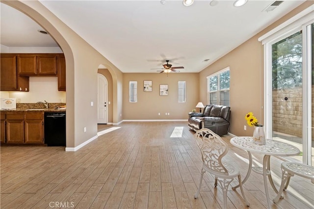 unfurnished living room with light wood-type flooring and ceiling fan