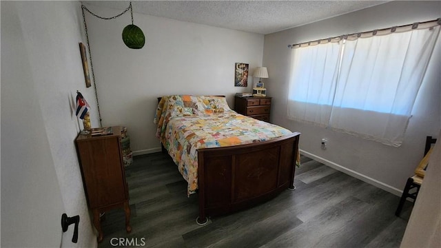 bedroom featuring dark wood-type flooring and a textured ceiling