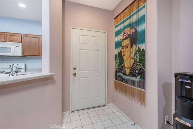 doorway with light tile patterned floors