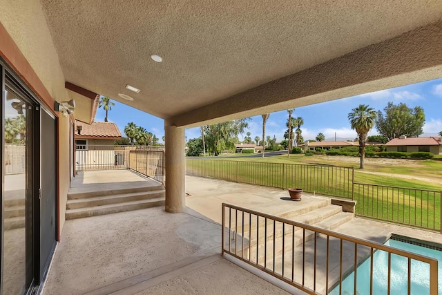 view of patio with a fenced in pool