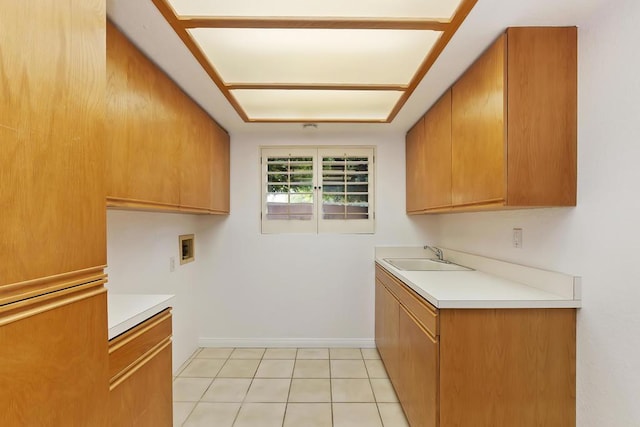 kitchen featuring light tile patterned flooring and sink