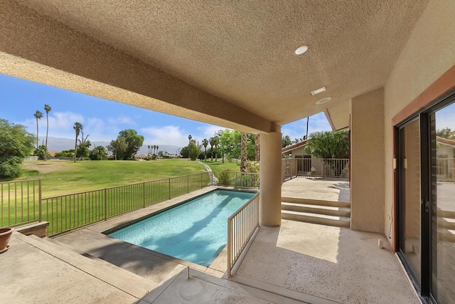 view of swimming pool featuring a patio and a lawn