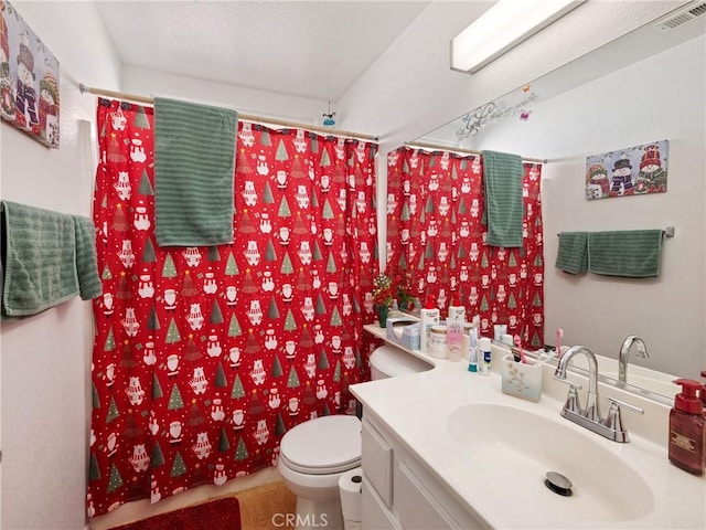 bathroom featuring a shower with shower curtain, vanity, and toilet