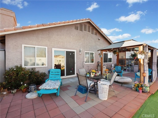 back of house featuring a gazebo and a patio area