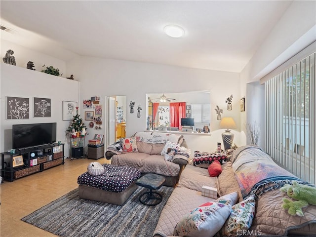 living room with ceiling fan and vaulted ceiling