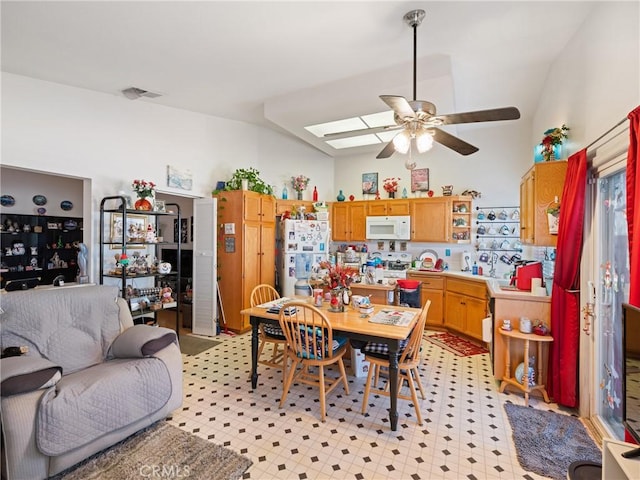 dining space with vaulted ceiling and ceiling fan