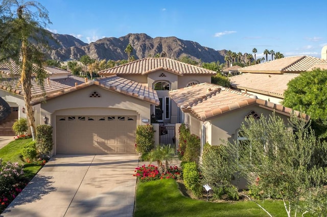 mediterranean / spanish-style home with a mountain view and a garage