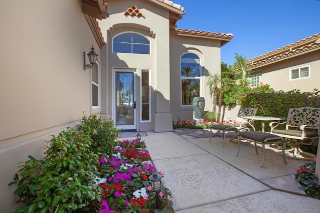 entrance to property with a patio