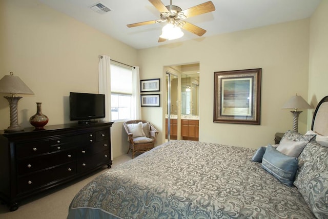 carpeted bedroom with connected bathroom and ceiling fan