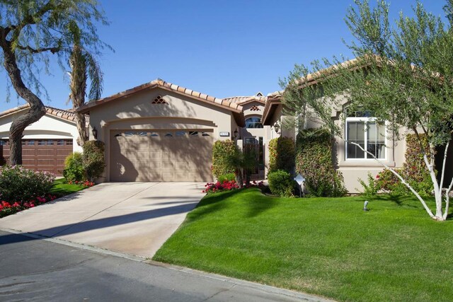 view of front of house featuring a garage and a front lawn