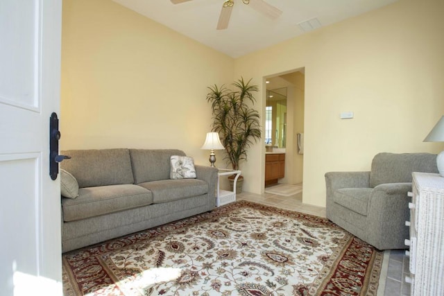 living room featuring ceiling fan and light tile patterned flooring