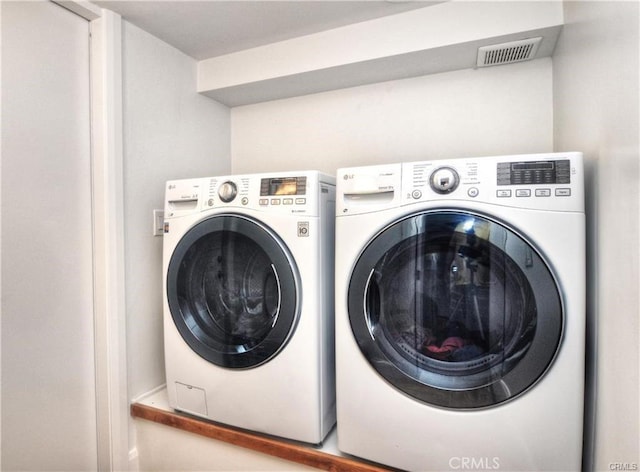 laundry room with washer and clothes dryer