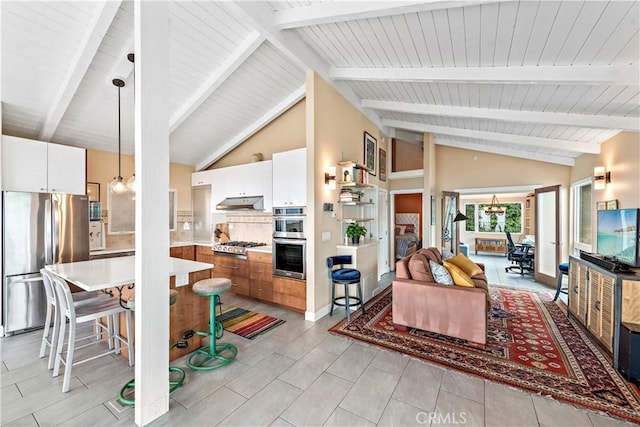 living room featuring beamed ceiling and high vaulted ceiling