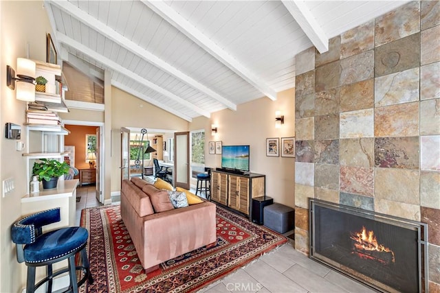 living room with beamed ceiling, wood ceiling, high vaulted ceiling, and a tiled fireplace