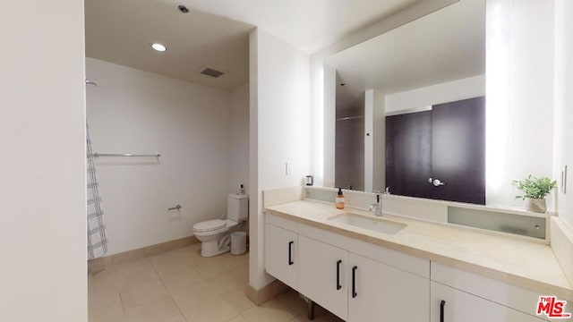 bathroom featuring toilet, vanity, and tile patterned floors