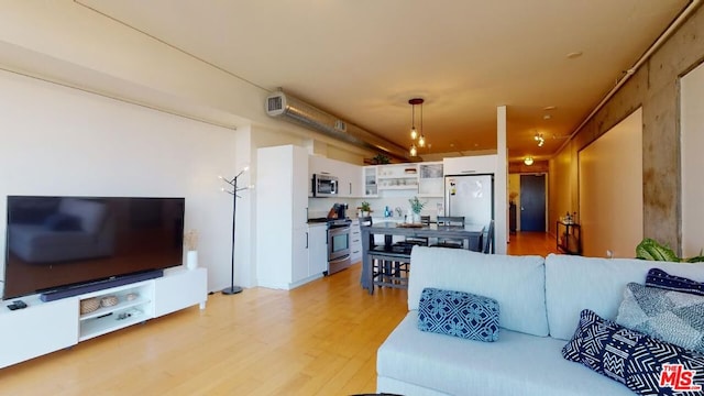 living room with sink and light wood-type flooring