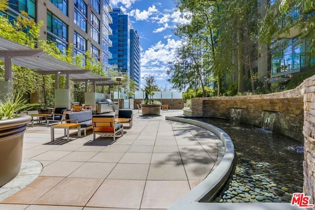 view of home's community featuring a pergola and a patio area