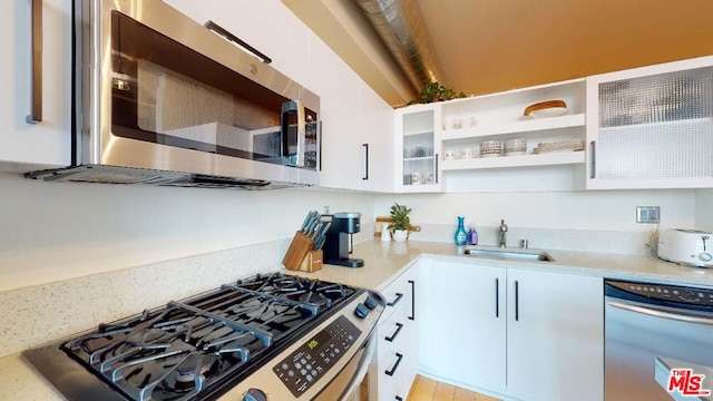 kitchen with white cabinets, sink, and stainless steel appliances