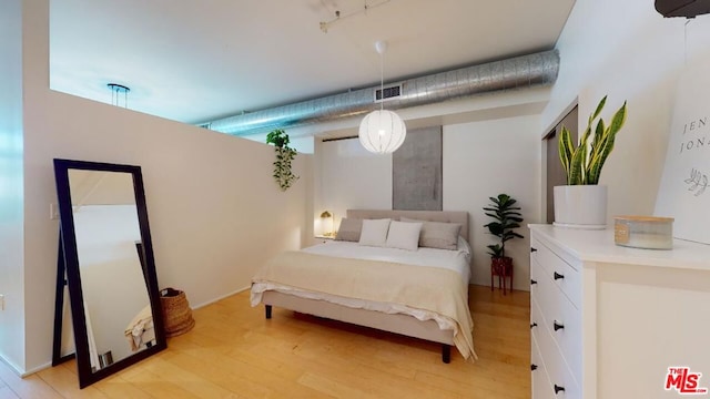 bedroom with light hardwood / wood-style flooring