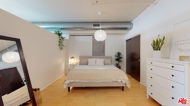 bedroom with light hardwood / wood-style floors