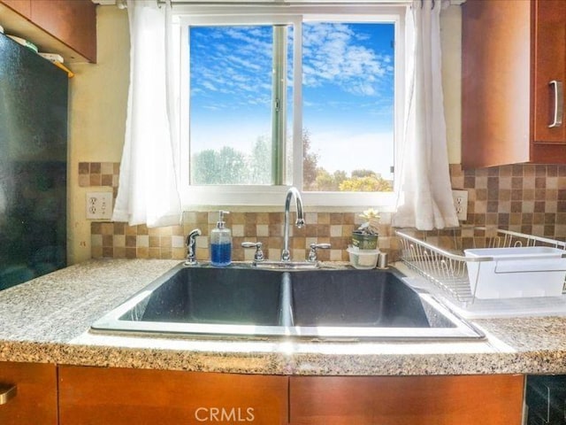 room details with light stone countertops and sink