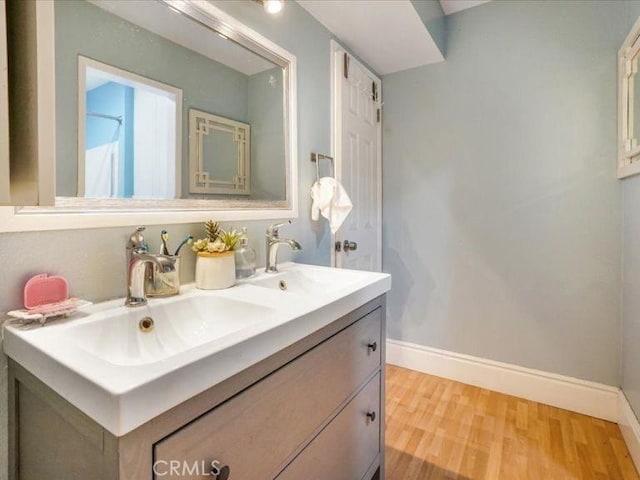 bathroom featuring vanity and hardwood / wood-style floors