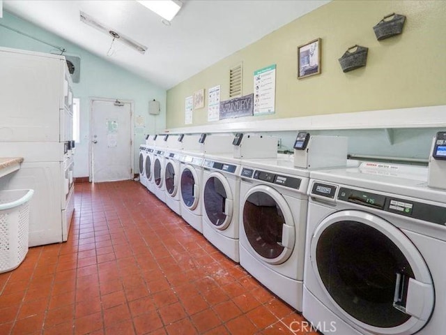 washroom with dark tile patterned floors and washing machine and clothes dryer