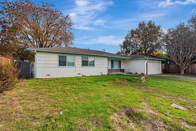 ranch-style house featuring a front yard and a garage