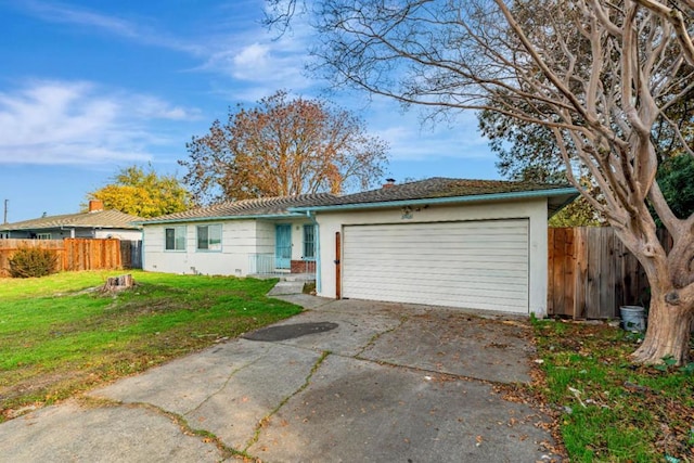 ranch-style house featuring a garage and a front lawn