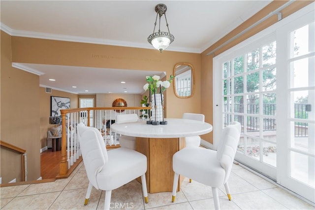 tiled dining area with plenty of natural light and crown molding