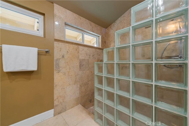 bathroom with tile patterned flooring and a shower