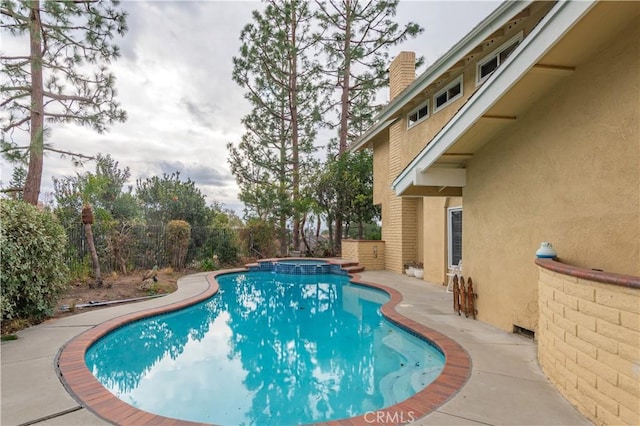 view of pool featuring an in ground hot tub