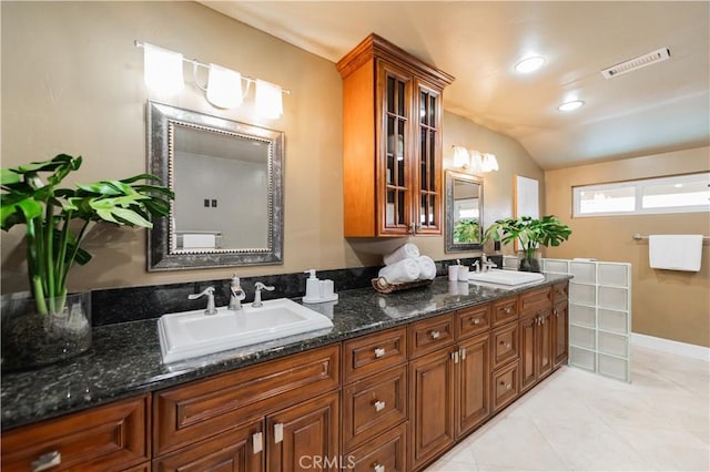 bathroom featuring tile patterned floors, vanity, and lofted ceiling