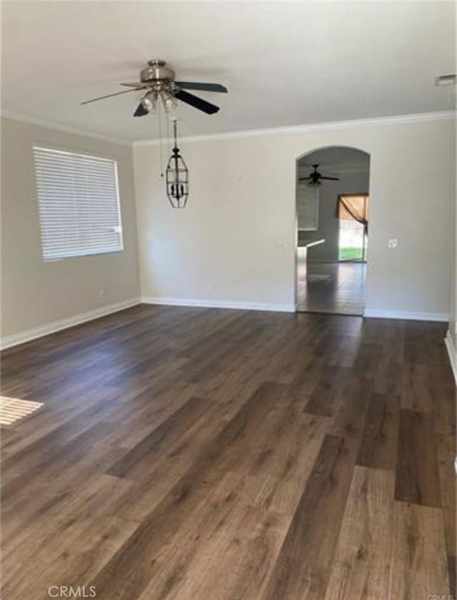 spare room with ceiling fan, dark hardwood / wood-style floors, and ornamental molding