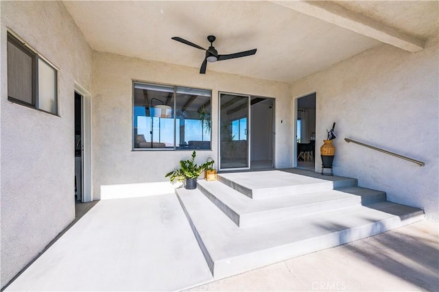 entrance to property featuring ceiling fan and a patio area