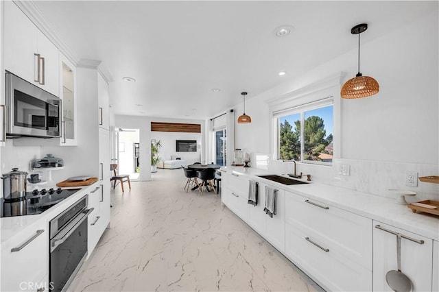 kitchen with sink, stainless steel appliances, and white cabinetry