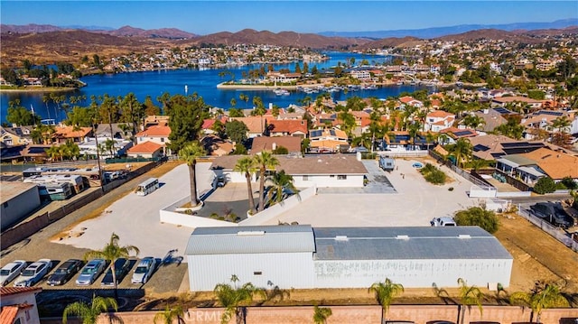 drone / aerial view featuring a water and mountain view