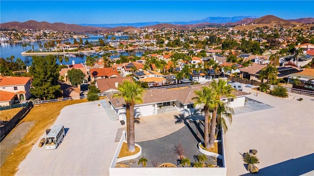 drone / aerial view with a water and mountain view