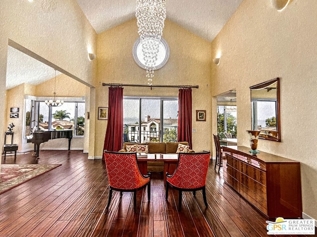 dining area featuring a notable chandelier, a wealth of natural light, and high vaulted ceiling