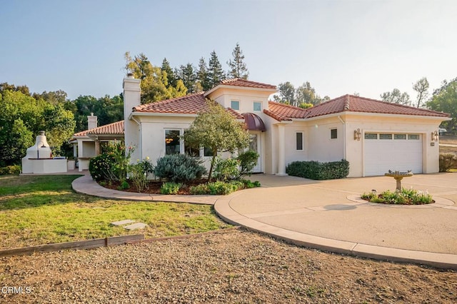 mediterranean / spanish house with a garage