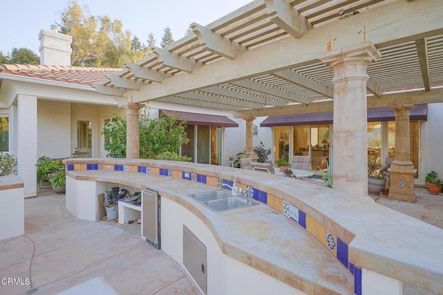 view of patio / terrace with a pergola and sink