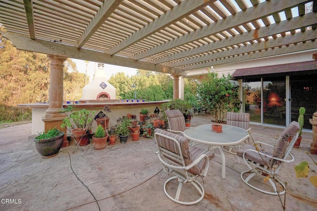 view of patio / terrace with a pergola and exterior fireplace