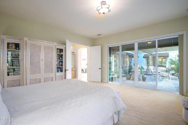 carpeted bedroom with access to exterior