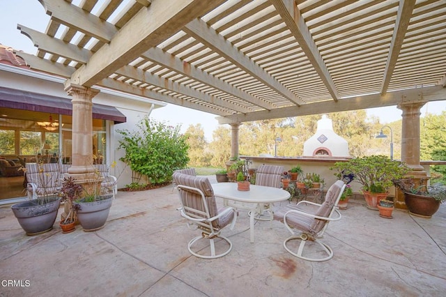 view of patio featuring a pergola and exterior fireplace