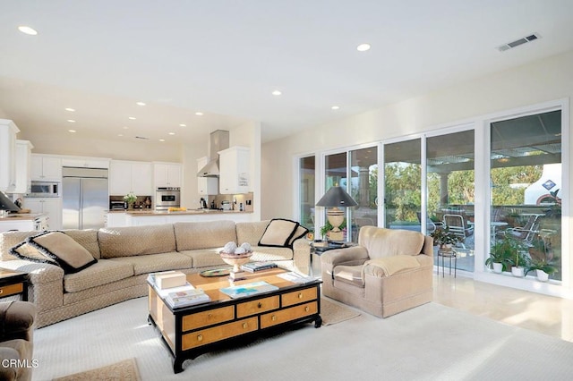 living room featuring light colored carpet and sink