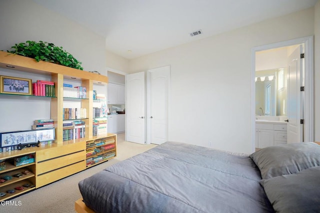 carpeted bedroom with ensuite bathroom