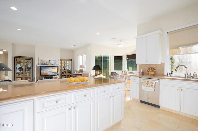 kitchen featuring dishwasher, white cabinets, plenty of natural light, and sink