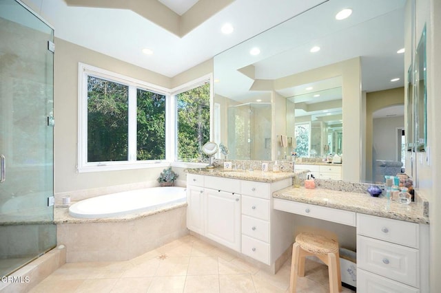 bathroom featuring tile patterned floors, vanity, and plus walk in shower